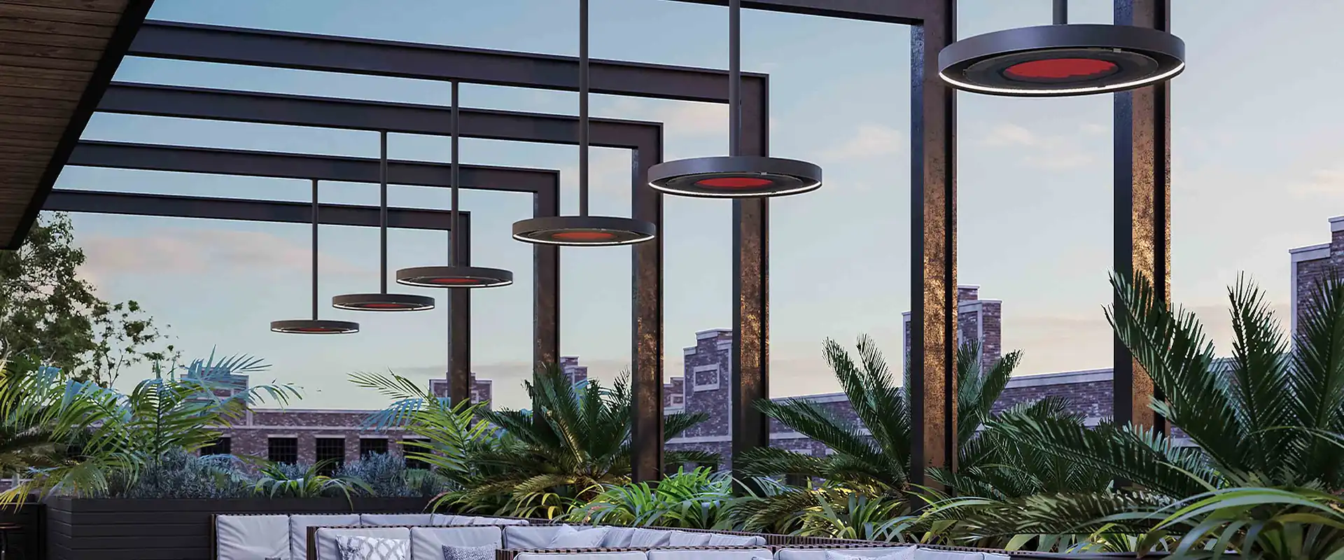 Row of Bromic Eclipse pendant heaters glowing red beneath a black steel pergola over a rooftop lounge at dusk