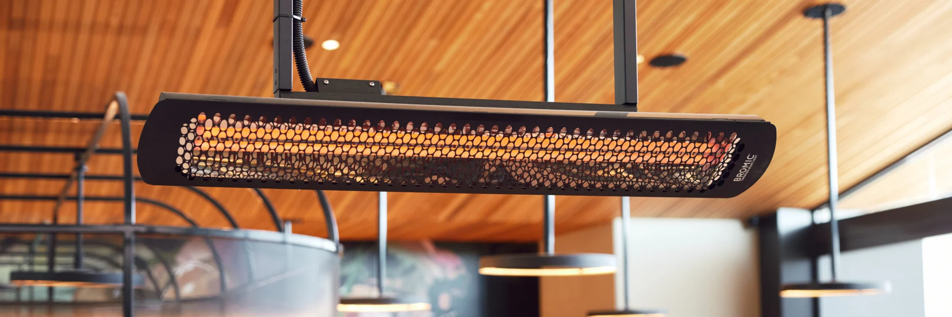 Bromic Tungsten Smart-Heat Electric heater hanging from a timber ceiling above a counter