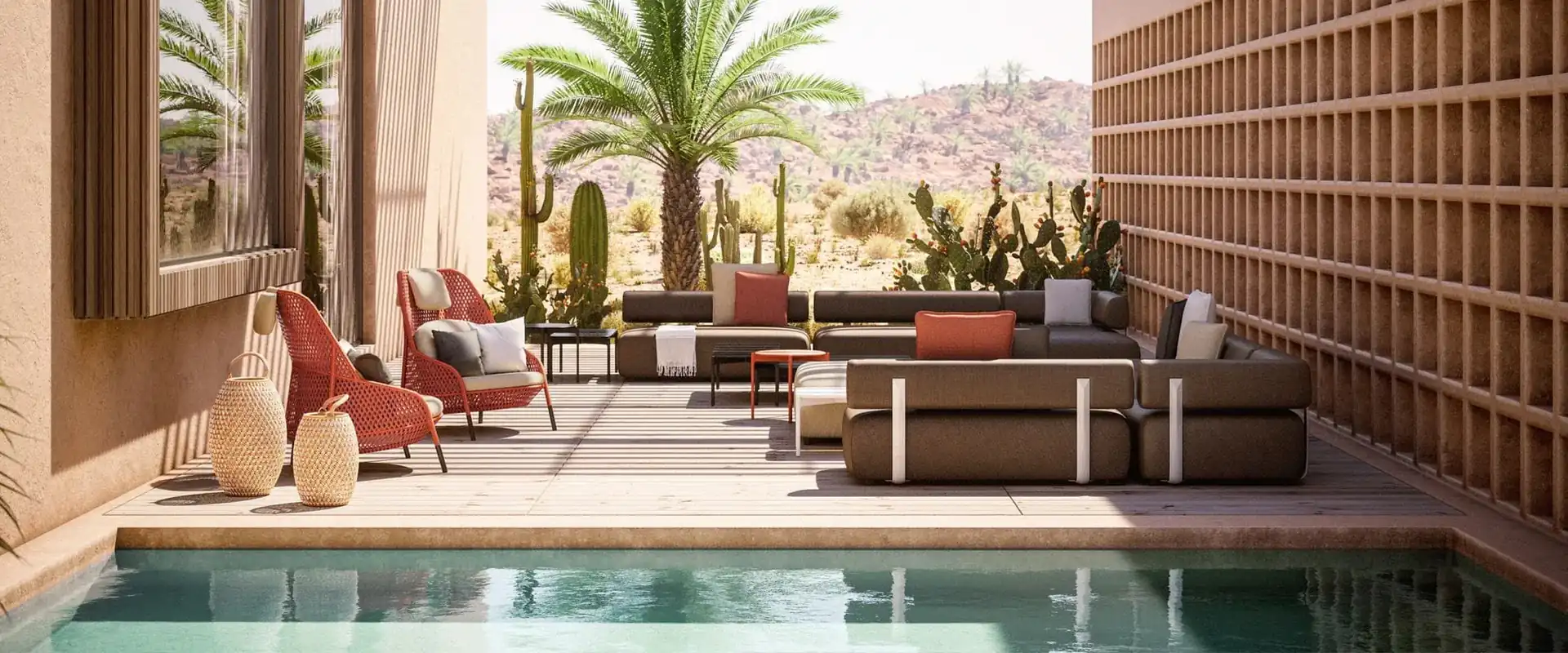 Dedon Brixx modular sofa with red accent chairs in a courtyard with a palm tree, a pool and desert hills