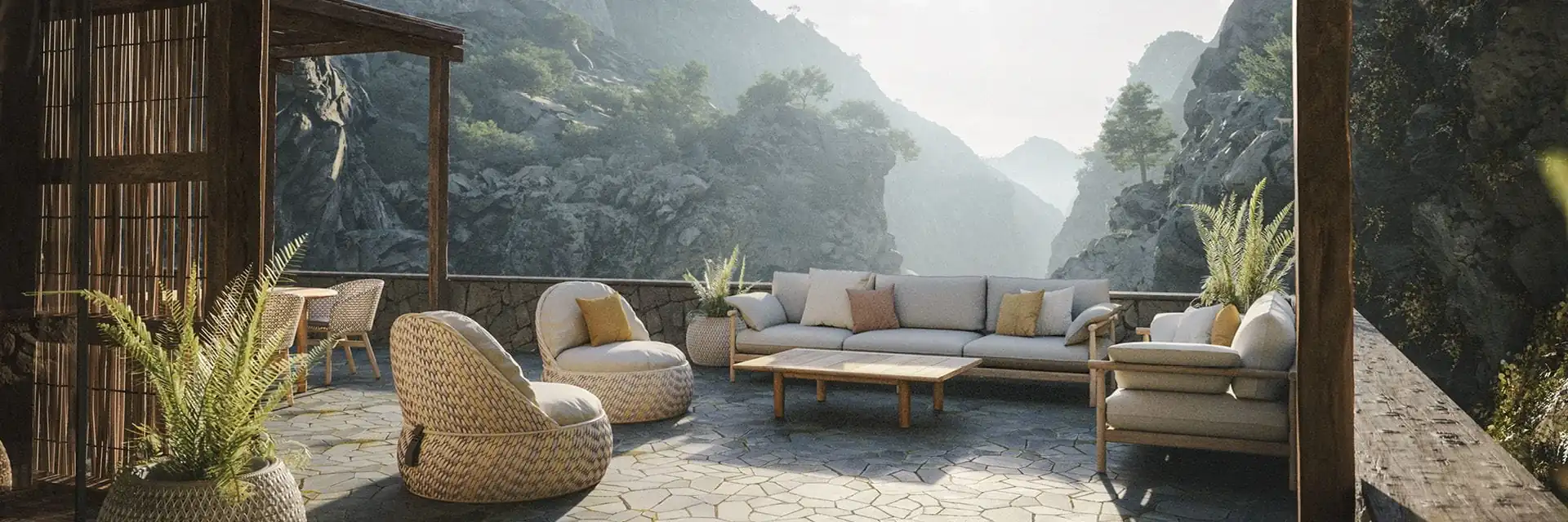 Dedon Dala lounge chairs and a Tibbo sofa on a stone-paved terrace facing a misty mountain valley