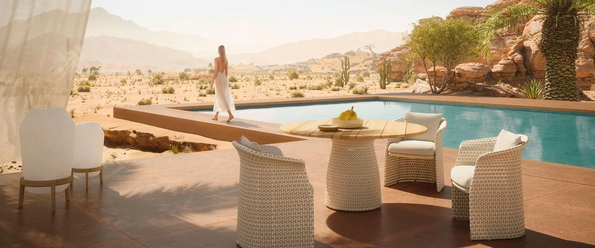 Dedon Fllair woven dining armchairs around a round table beside a pool, with a desert landscape behind