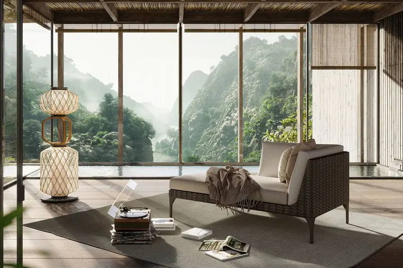 Dedon MU modular sofa in a glass-walled pavilion with a lantern, looking out to misty mountains