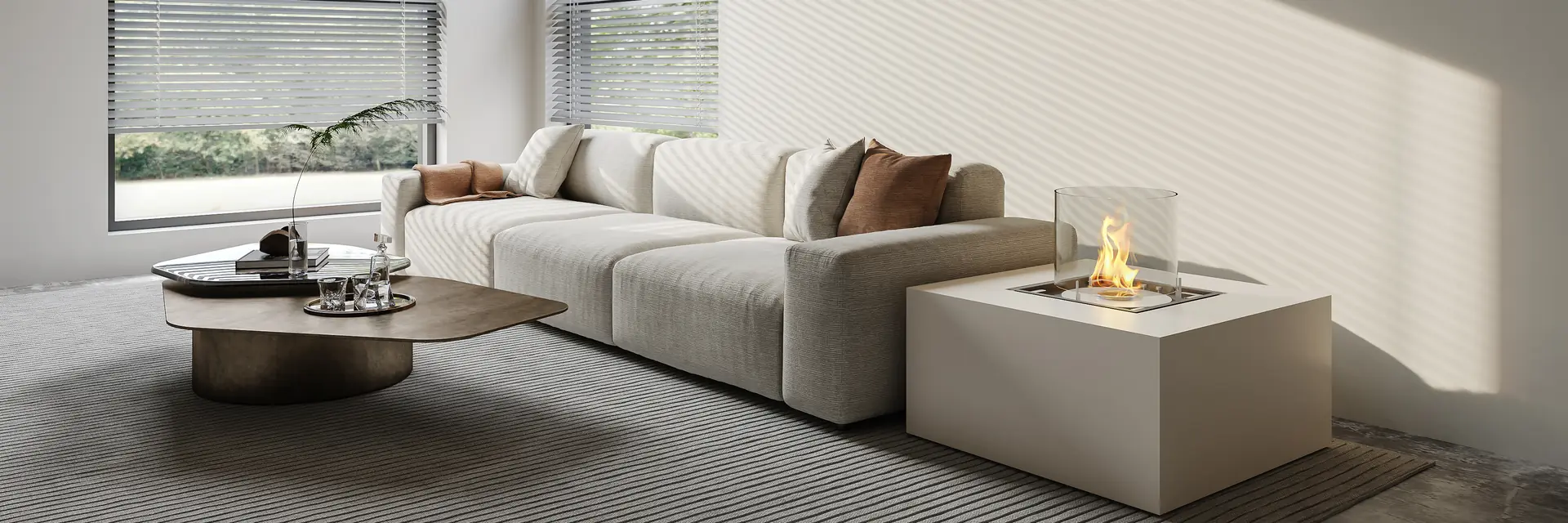 EcoSmart Chaser 38 fire table in white with a glass screen, burning beside a pale sofa in a bright living room with large windows