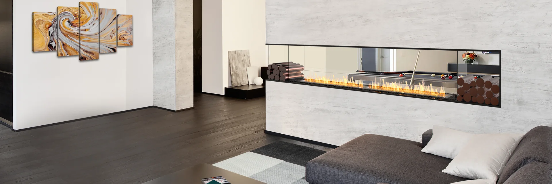 EcoSmart Fire Flex peninsula fireplace burning at the end of a white marble wall, beside a gray corner sofa