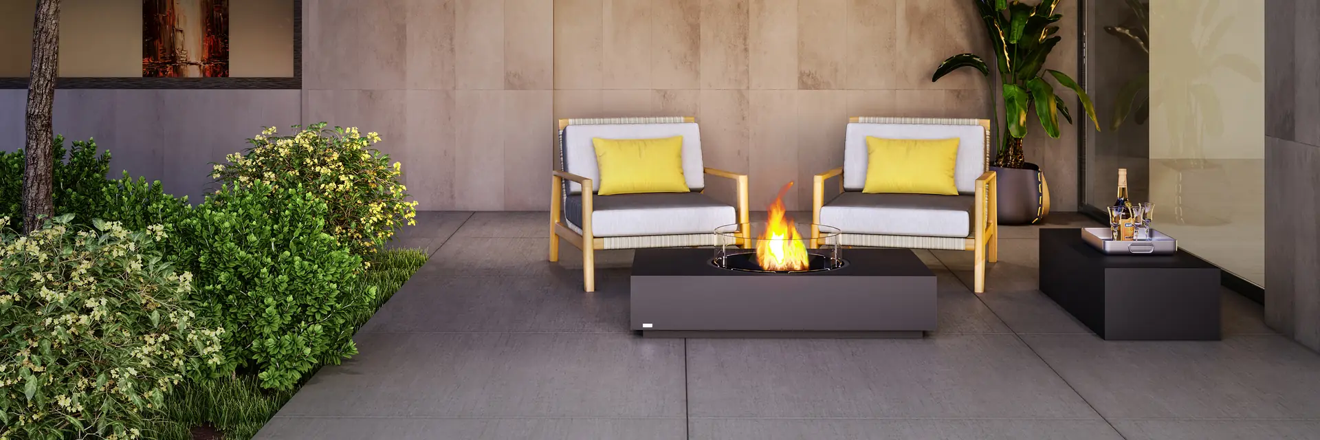 EcoSmart Martini 50 fire table burning between two armchairs with yellow cushions in a covered courtyard with stone walls and plants