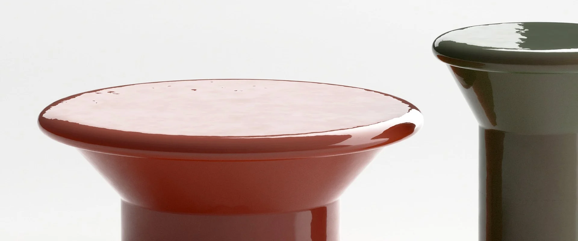 Close view of Ethimo Tama glazed ceramic coffee tables in red and dark green
