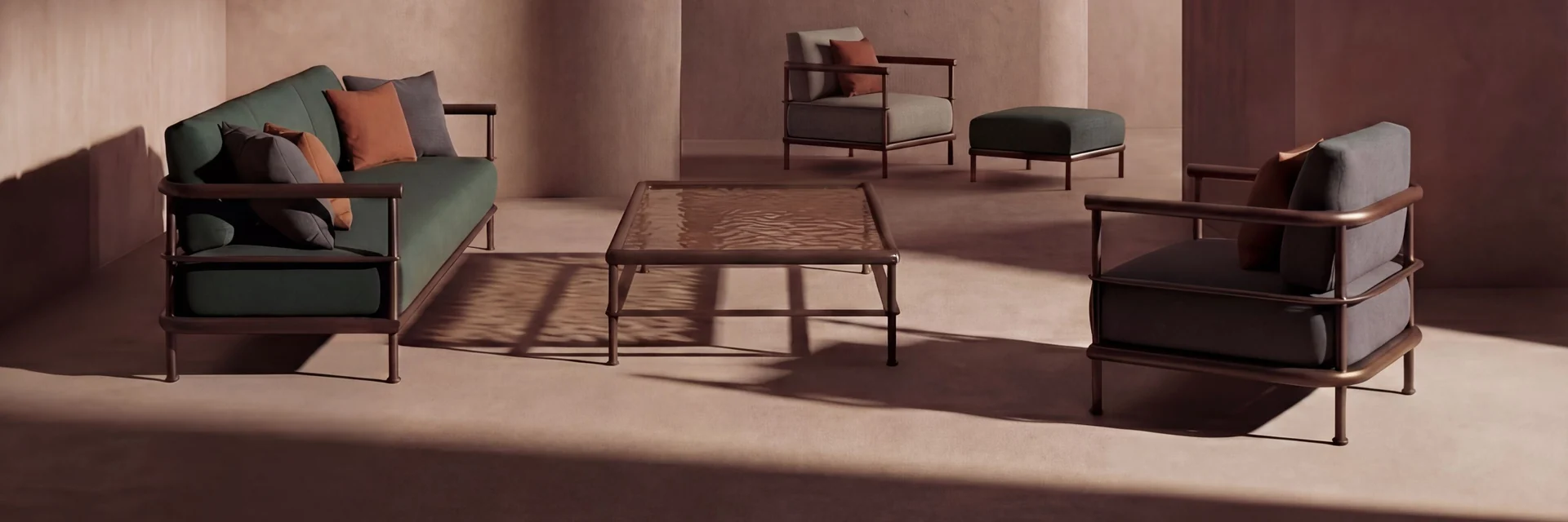 Kettal Alize sofas and armchairs in a courtyard of terracotta-coloured walls, in low light