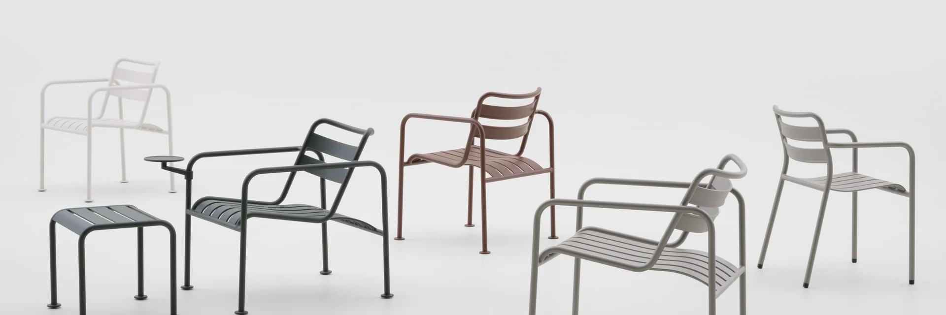 Kettal Atlantic chairs, lounge chairs and stools in several colours against a pale grey studio backdrop