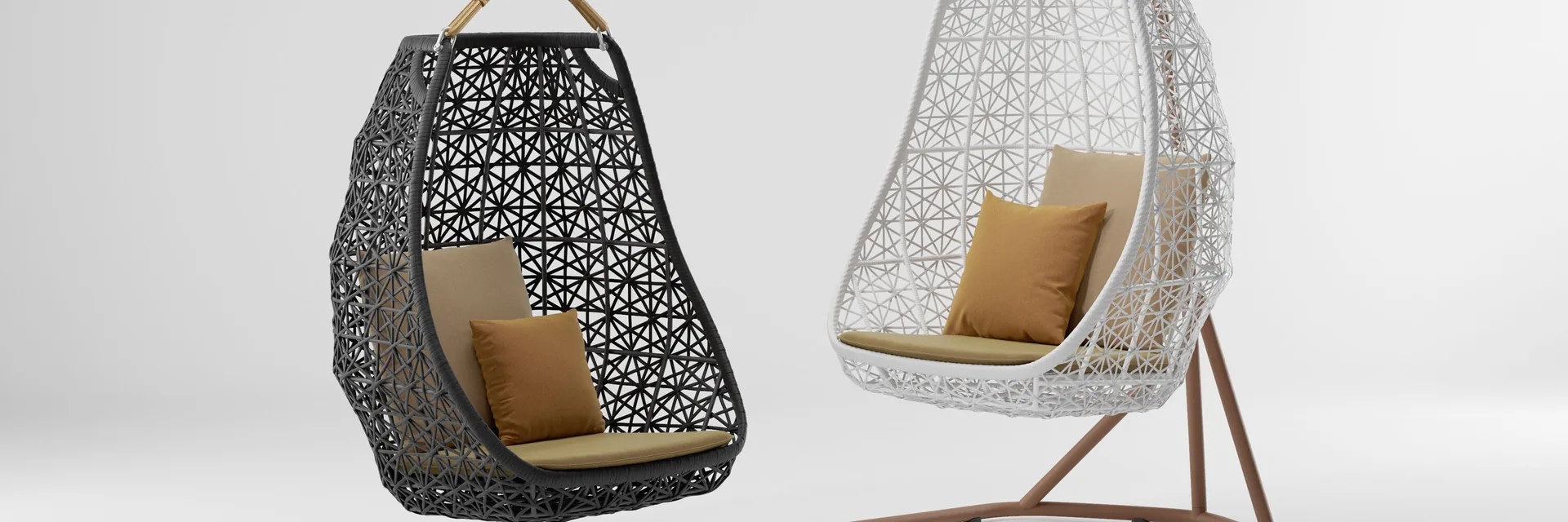 Two Kettal Maia hanging egg chairs, one black and one white, with mustard cushions against a pale studio backdrop