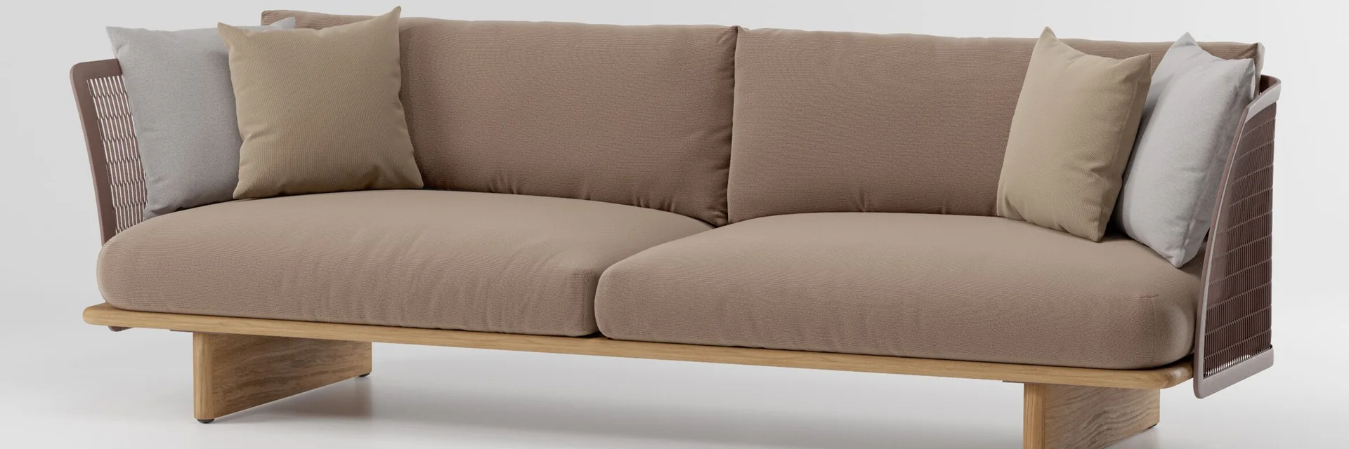 Kettal Mesh three-seater sofa with a perforated metal frame, teak base and taupe cushions, against a pale studio backdrop