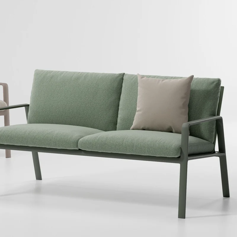 Kettal Park Life two-seater sofa with a dark green aluminum frame and green cushions, on a plain studio background