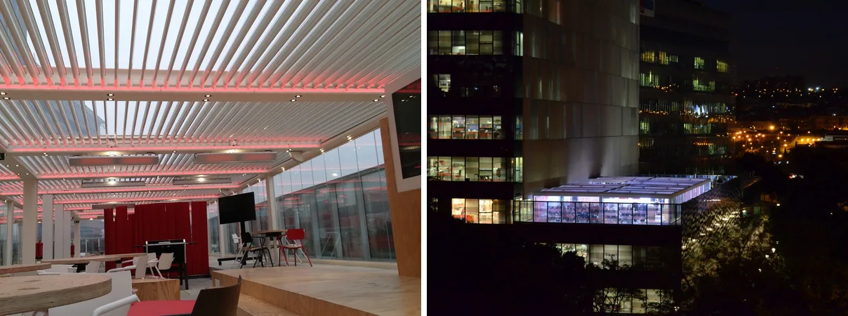 Bioclimatic pergola on the terrace of Mahou San Miguel’s Madrid headquarters, with infrared heaters under the louvres and the glazed terrace lit up at night