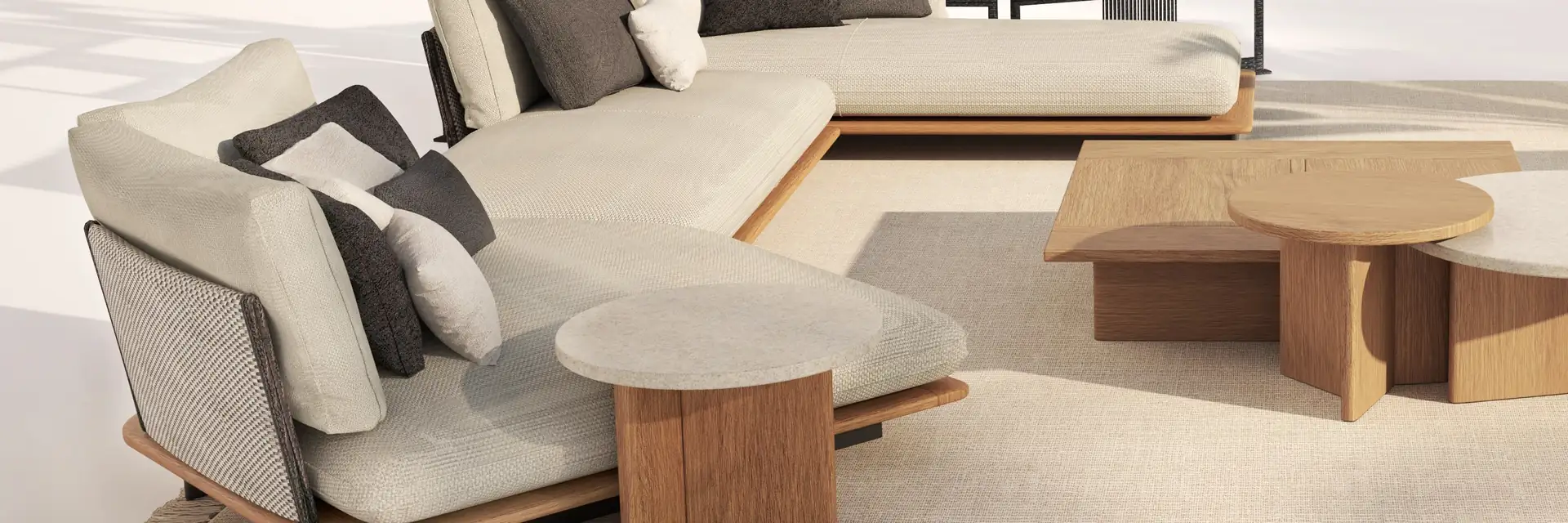 Talenti Venice corner sofa with pale cushions and a teak coffee table on a sunlit terrace, with dark lattice screens behind
