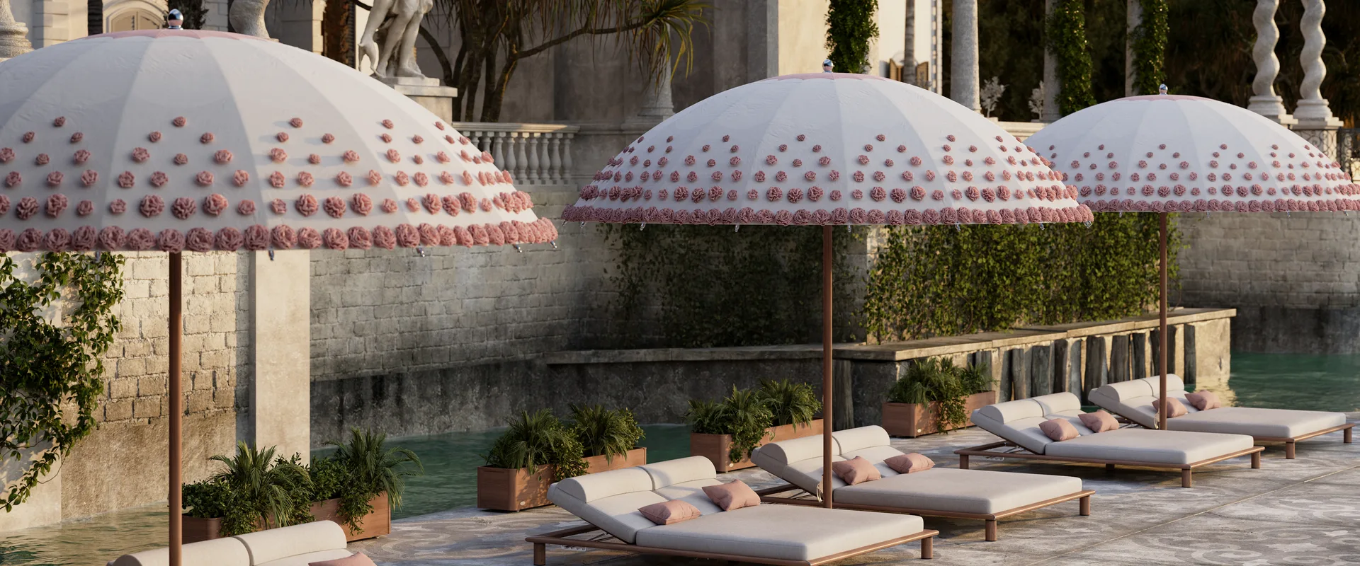 Three Tuuci Ocean Master MAX Bolero Ombré Blossom parasols with hand-tufted pink blossoms over sun loungers beside the pool of a lakeside villa