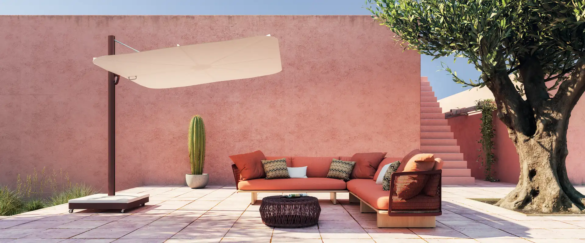 Umbrosa Versa UX cantilever parasol over an outdoor sofa against a terracotta wall with an olive tree