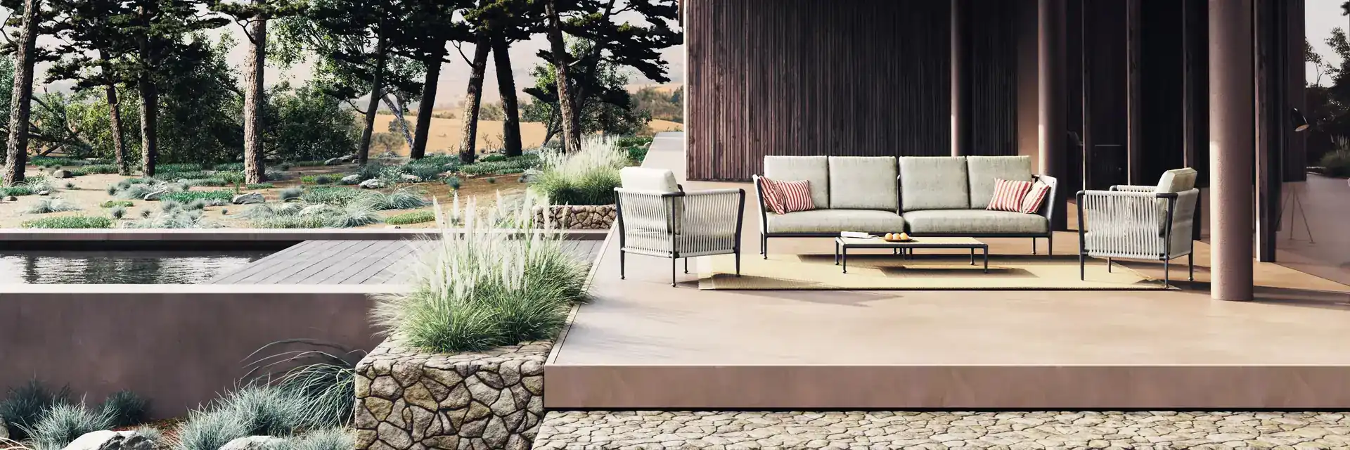 Unopiù Treble lounge set under the portico of a dark modern house in a garden of pines
