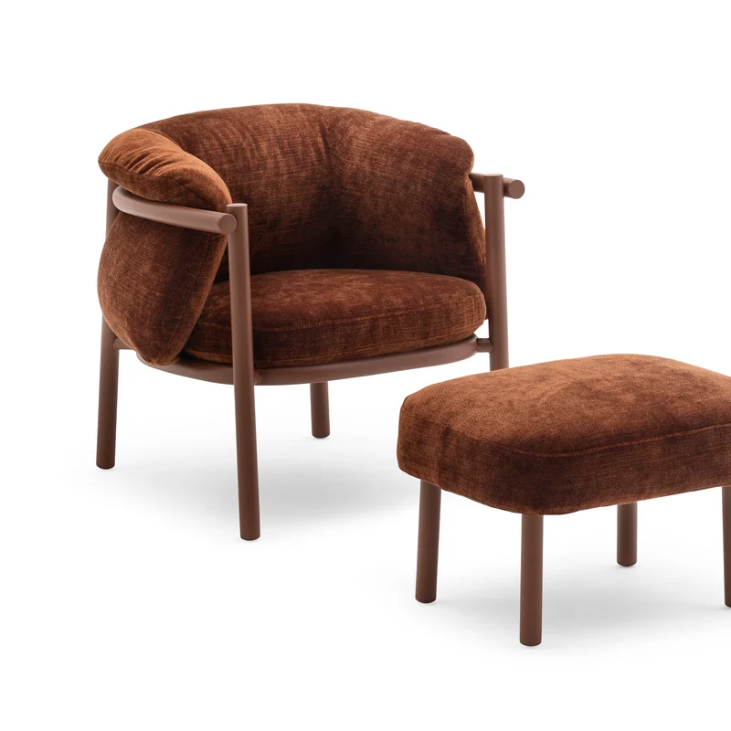 Varaschin Allegra armchair with a soft brown cushioned shell on a slim frame, with its matching footstool, on a white background