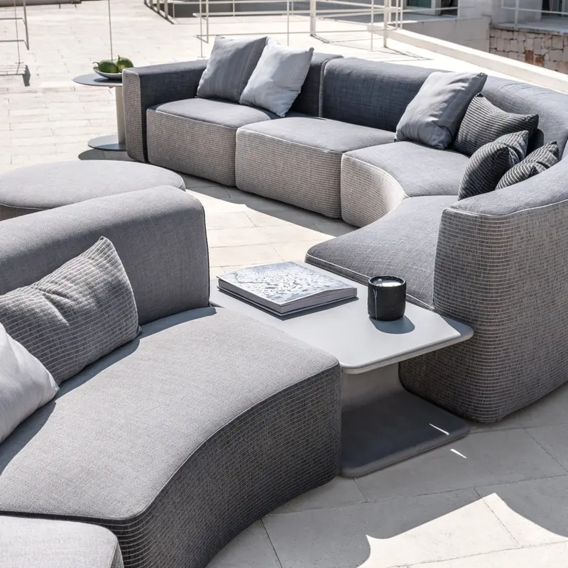 Varaschin Belt curved modular sofas with gray cushions and woven belt bases, with a low table between them